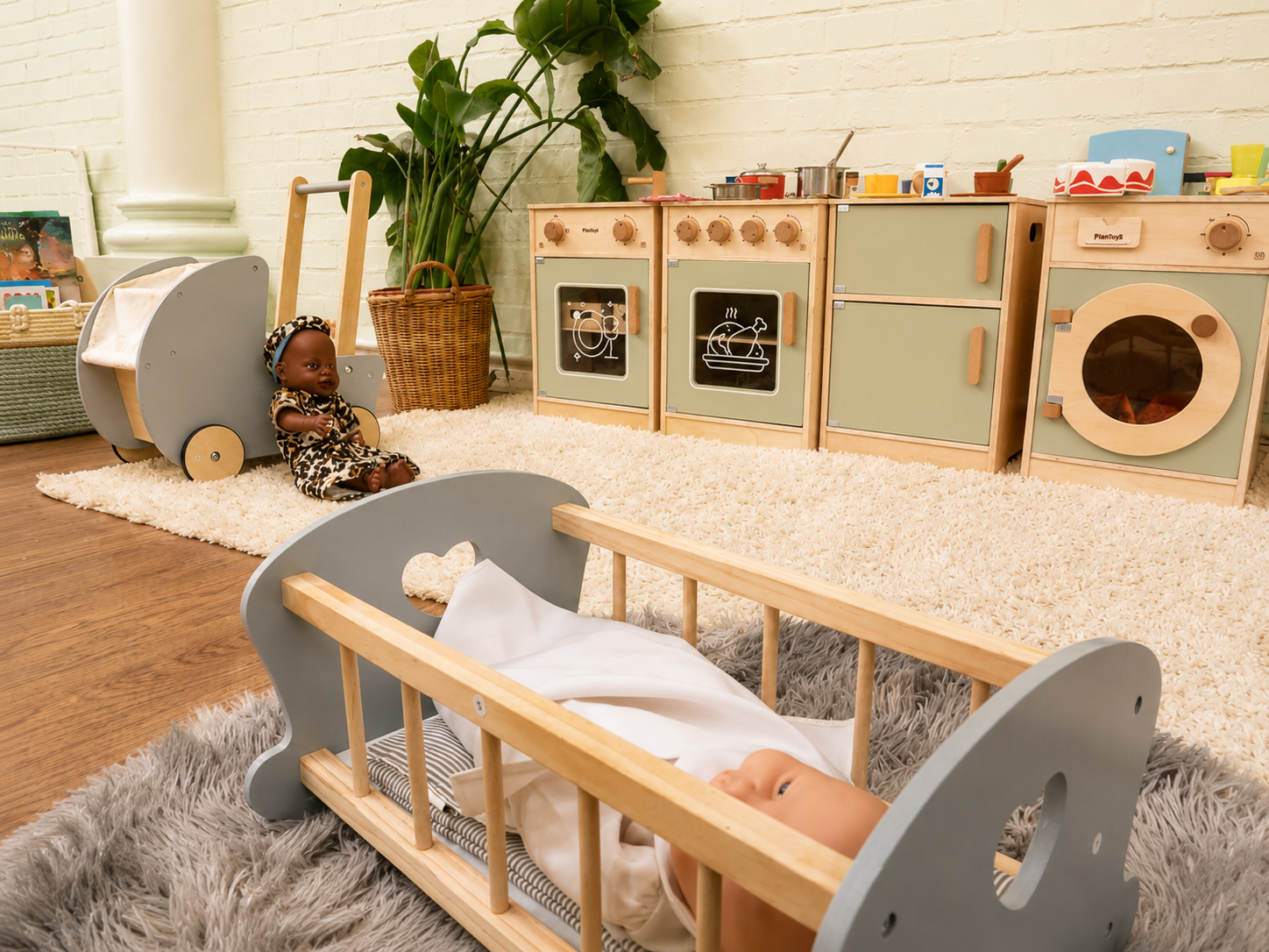 The role-play kitchen and reading corner in our toddler room