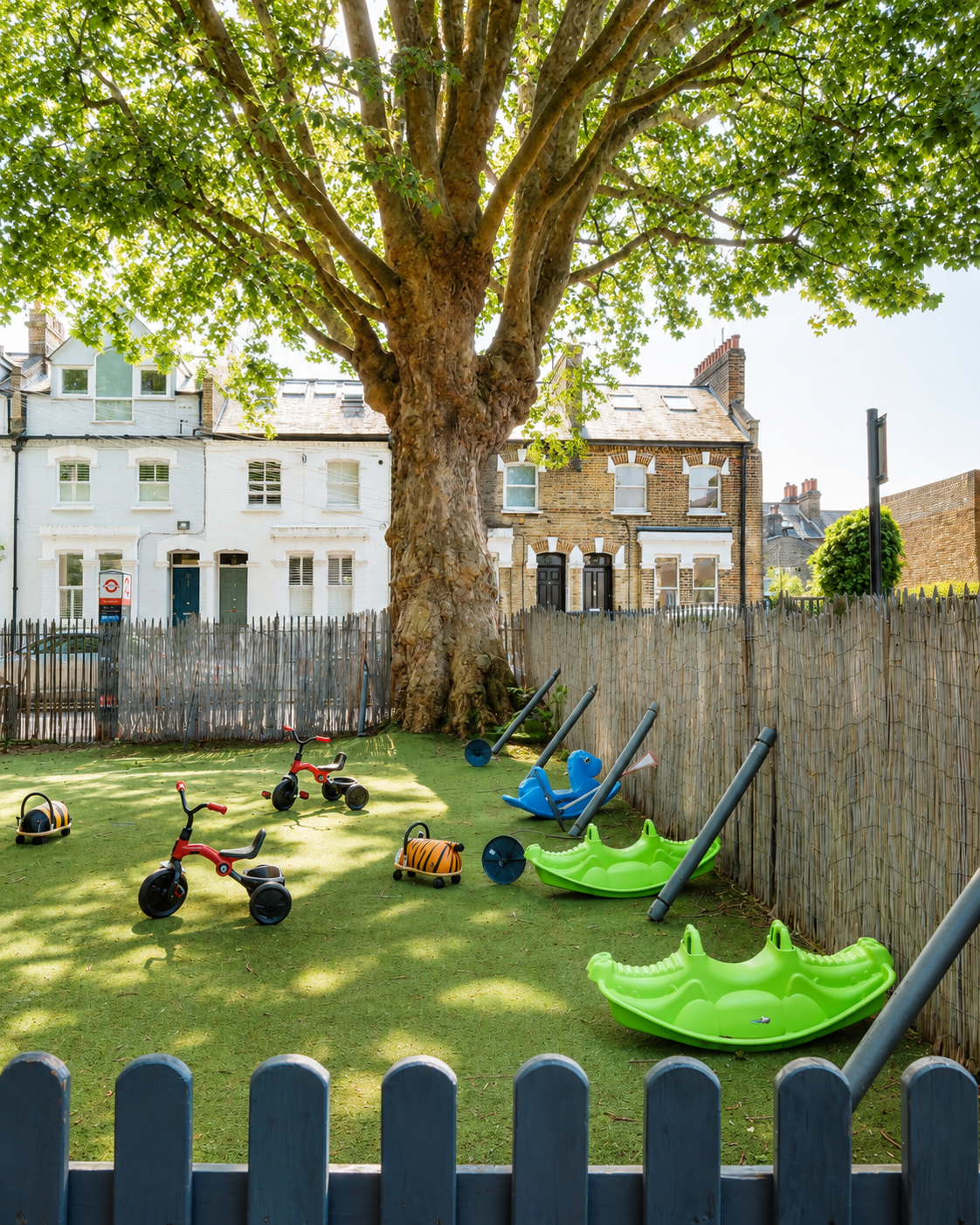 Our private leafy garden in Fulham, with ride-ons under a mature plane tree